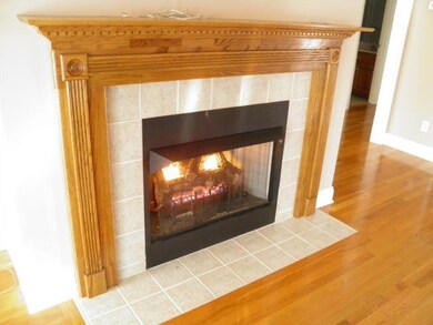 This fireplace can be the focal point of your living area.  Tile surround with beautiful wood mantle. 