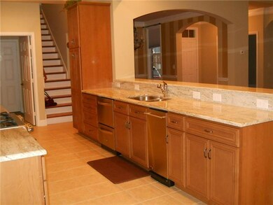 Other kitchen features include stainless steel upgraded appliances & sink, a trash compactor & plenty of counter work space on both sides of the room.