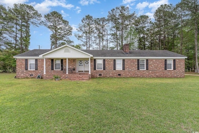 Single story home with a front yard, brick siding,