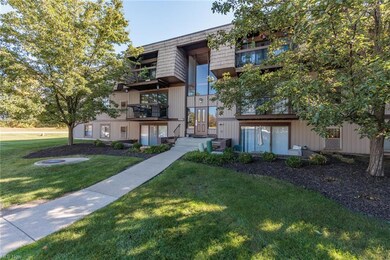 View of front of house featuring a balcony and a front lawn