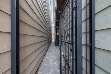 Private entrance is located behind a secure, gated
