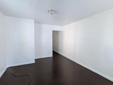 Unfurnished room with baseboards