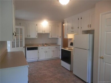 Kitchen w/ Appliances. ( stove, refrigerator, dish