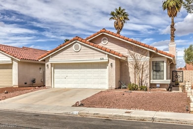 View of front of property featuring a garage, a ti