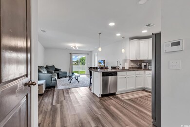 Kitchen with stainless steel dishwasher, white cab