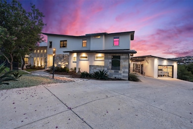 Contemporary home featuring stone siding, stucco 