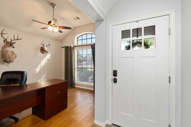 This home features a beautiful front door, which lets in additional light.  As you enter you will find the study to the right with beautiful hardwood floors and arched windows