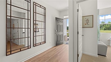 Entrance foyer with baseboards and wood finished floors
