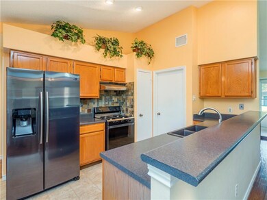 Kitchen featuring stainless steel refrigerator wi