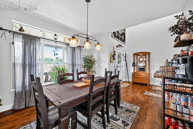 Dining room featuring dark wood-type flooring