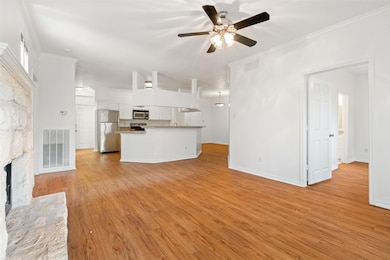 Unfurnished living room featuring a ceiling fan, 