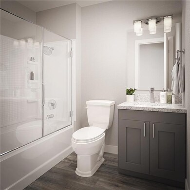 Bathroom with baseboards, wood finished floors, to