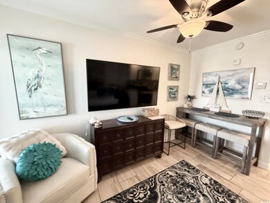 Living room featuring ceiling fan, wood finish flo