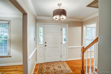 The Foyer has lovely hardwood flooring, crown molding, and chair rail.