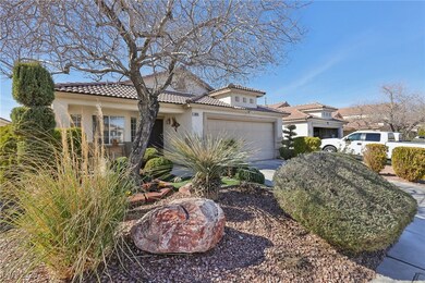 Mediterranean / spanish-style home featuring a gar