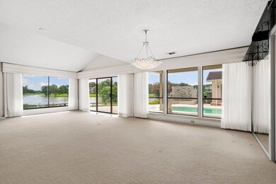 A wall of windows and sliding glass doors fill the