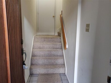 Front entrance stairs and the door to garage
