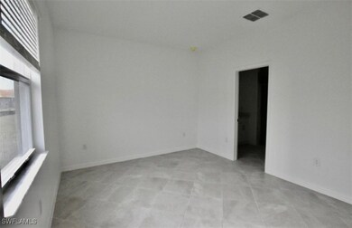 Unfurnished room featuring visible vents and baseb