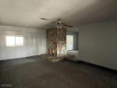 Unfurnished living room with ceiling fan, a textur
