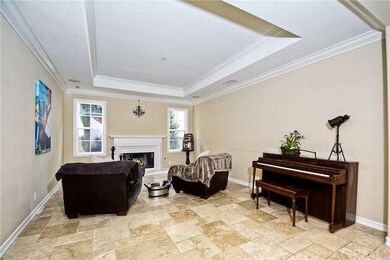 Travertine flooring throughout lower level, dramat
