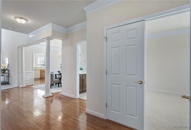 Entrance foyer with ornate columns, hardwood / woo