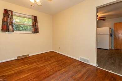 Empty room featuring dark hardwood flooring and ce