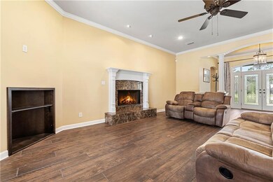 Living room with crown molding, decorative columns