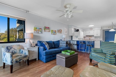 Living room with wood finished floors, a ceiling f