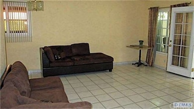 Spacious living room with ceramic tile floors & sc