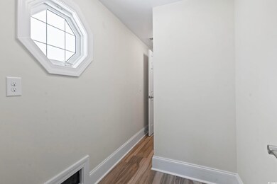 Corridor with baseboards and wood finished floors