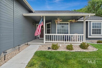View of exterior entry with a porch, roof with shingles, and a lawn