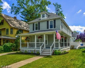 View of front of home with a front yard and a porch