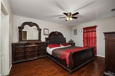 Bedroom featuring baseboards, a ceiling fan, dark wood-style floors, and visible vents