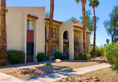 View of front of home with stairs, a tile roof, an