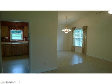 Living Room. View into the dining room and kitchen.