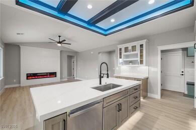 Kitchen featuring a large electric fireplace, quar