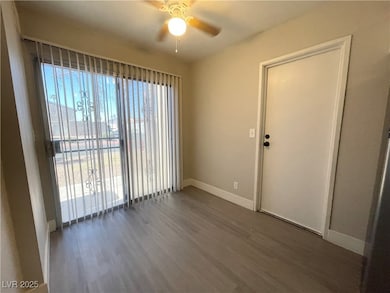 Empty room with ceiling fan, wood finished floors,