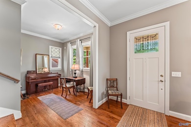 Just around the corner is builtin shelving for storing guests purses/shoes, etc conveniently close to the door & out of sight as well as COAT CLOSET, and a built-in desk area for anyone to do work quietly but still be in the loop of happenings.