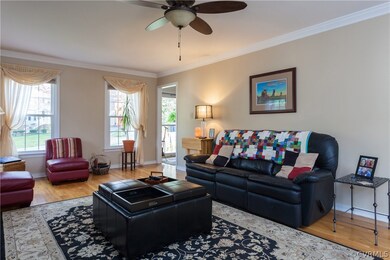 Great room with hardwood floors, crown molding and