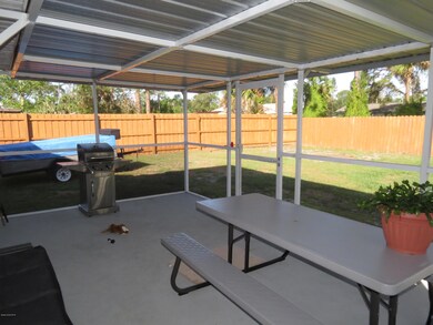 Screen porch with fenced in yard