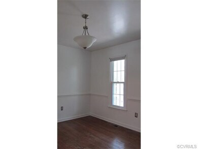 Dining Room with hardwood floors and chair rail mo