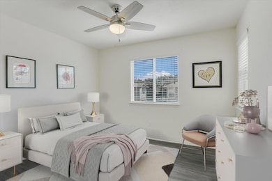 Bedroom with wood finished floors and ceiling fan