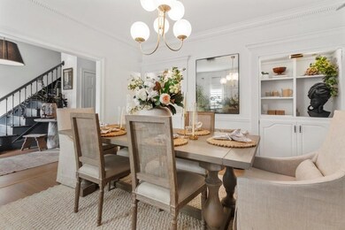 Dining room featuring stairway, crown molding, a chandelier, and wood finished floors