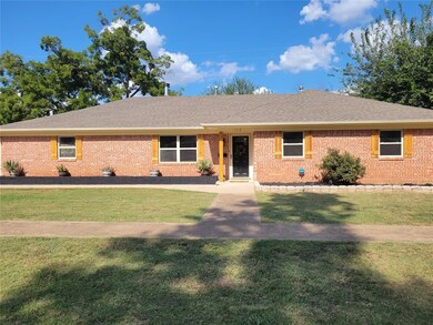 Ranch-style home featuring a front lawn