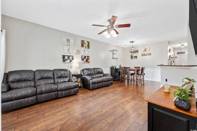 Living room with hardwood / wood-style floors and 