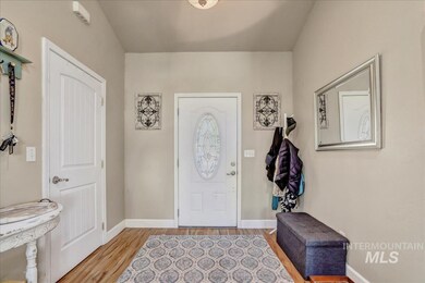 Foyer entrance with light wood finished floors and baseboards
