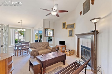 Carpeted living room featuring ceiling fan with no