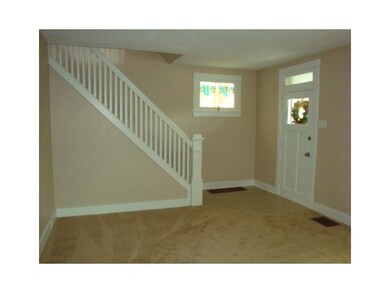 Living Room. Craftsman style staircase leads to th