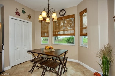 Dining room featuring a chandelier and light tile patterned flooring