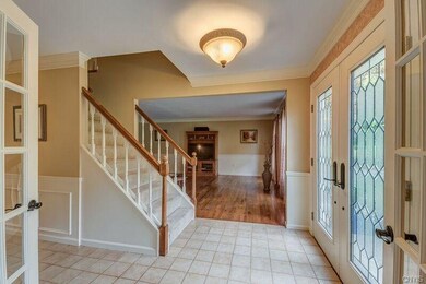 Spacious Grand foyer with ceramic tile and large c